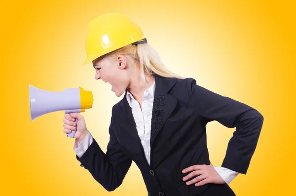 Female construction worker with loudspeaker — Stock Photo, Image