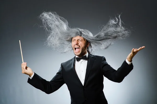 Funny conductor with long grey hair — Stock Photo, Image