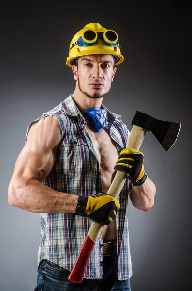 Ripped muscular builder man with tools — Stock Photo, Image