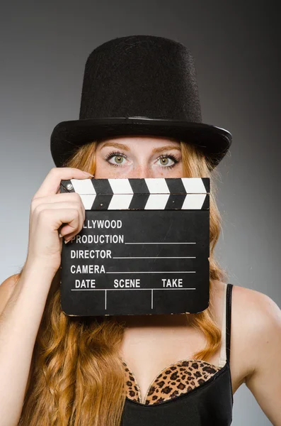 Woman with movie board wearing hat — Stock Photo, Image