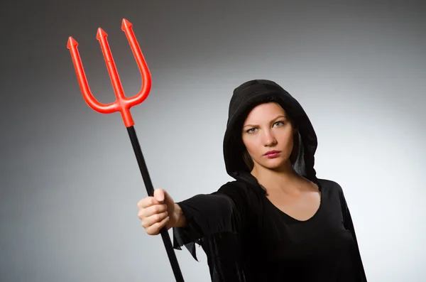 Woman holding pitchfork — Stock Photo, Image