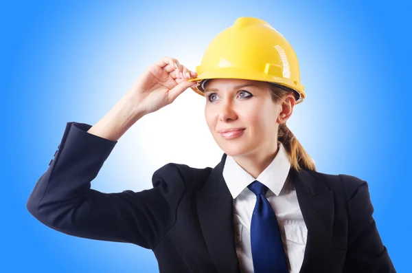Young businesswoman with hard hat on white Stock Picture