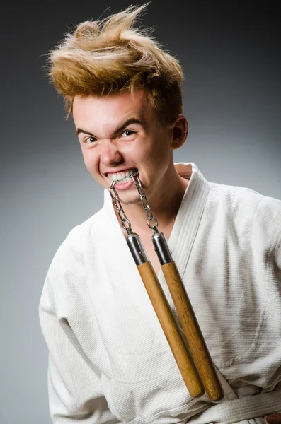 Divertido luchador de karate con nunchucks — Foto de Stock