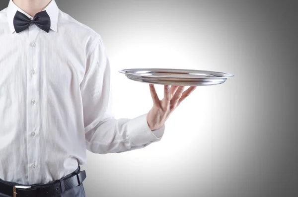 Young waiter with silver tray — Stock Photo, Image