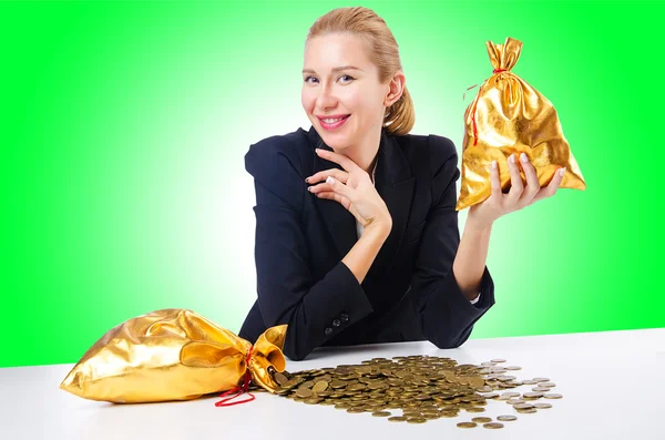 Woman with coins and golden sacks — Stock Photo, Image