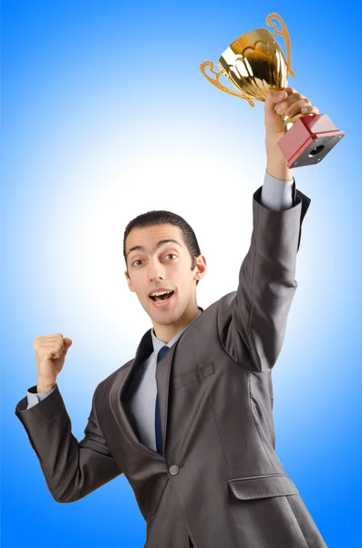 Man being awarded with golden cup Stock Image