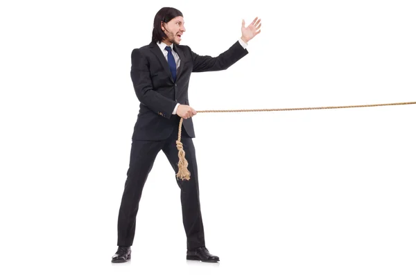 Jovem empresário puxando corda isolada no branco — Fotografia de Stock
