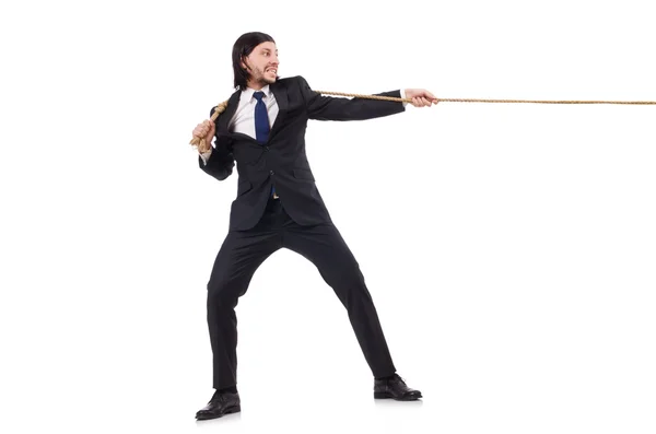 Joven empresario tirando de la cuerda aislada en blanco — Foto de Stock