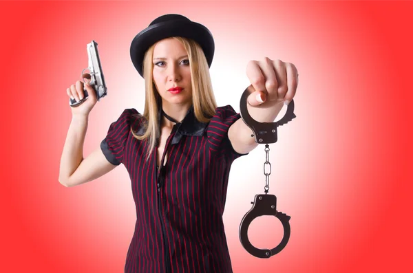 Woman with gun and money — Stock Photo, Image