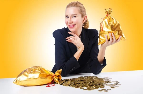 Woman with golden sacks — Stock Photo, Image