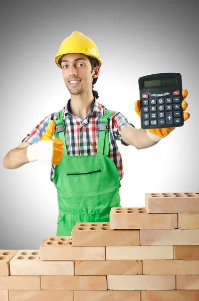 Hombre con constructor y calculadora Fotos de stock libres de derechos