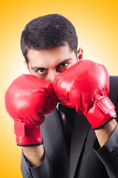 Young businessman with boxing gloves — Stock Photo, Image