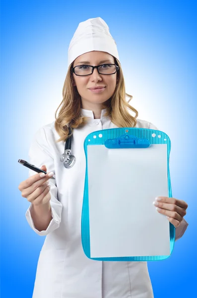 Woman doctor with empty table — Stock Photo, Image