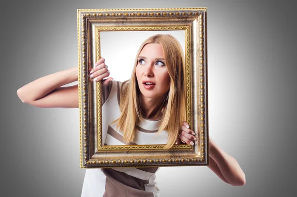 Woman with picture frame — Stock Photo, Image