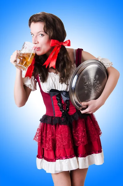 Bavarian girl with tray on blue — Stock Photo, Image