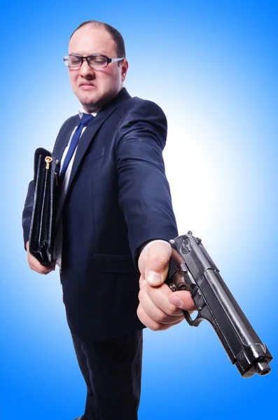 Empresário com arma em azul — Fotografia de Stock