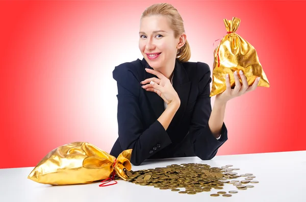 Woman with golden sacks — Stock Photo, Image