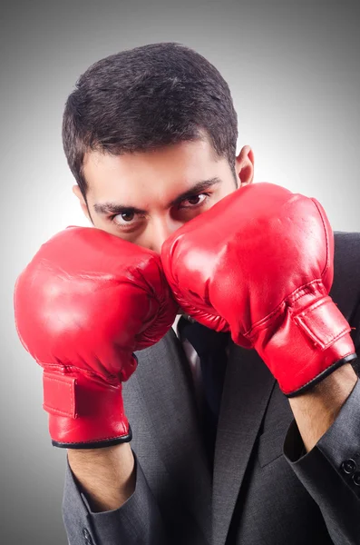 Young businessman with boxing gloves — Stock Photo, Image