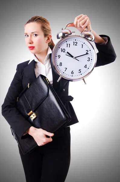Businesswoman with giant clock — Stock Photo, Image