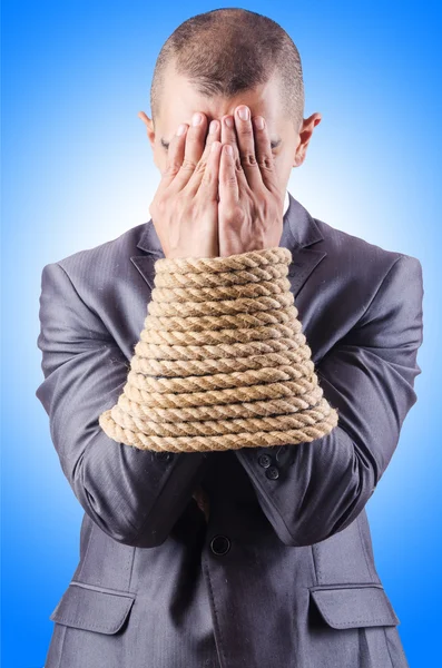 Businessman tied up with rope — Stock Photo, Image