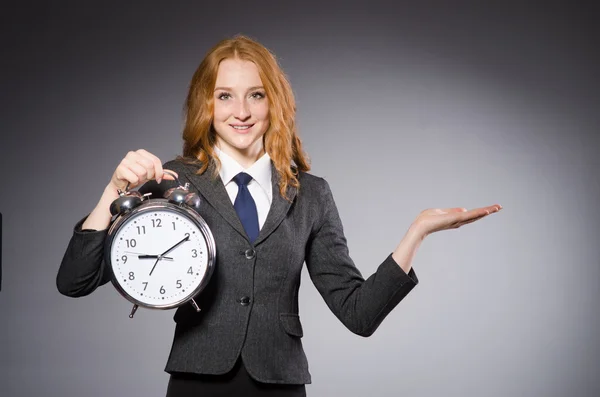 Businesswoman with clock being late — ストック写真