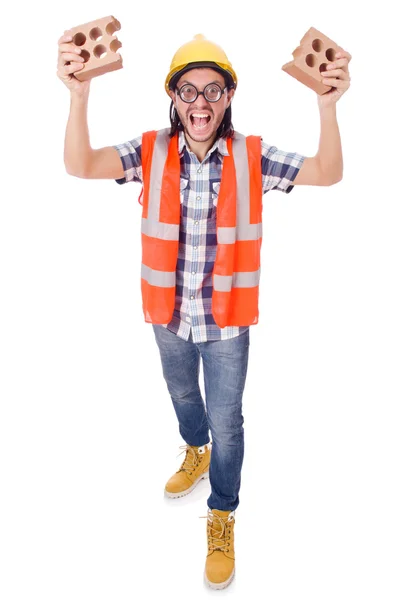 Engraçado jovem trabalhador da construção com tijolo quebrado isolado em branco — Fotografia de Stock