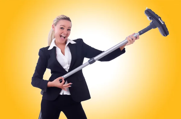 Businesswoman with vacuum cleaner against the gradient — Stock Photo, Image