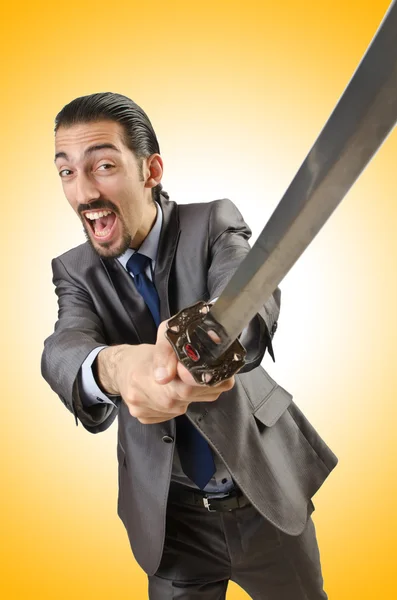 Businessman with sword against the gradient — Stock Photo, Image