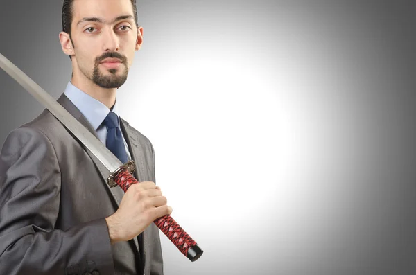 Businessman with sword against the gradient — Stock Photo, Image