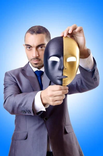 Businessman with mask in hypocrisy concept — Stock Photo, Image