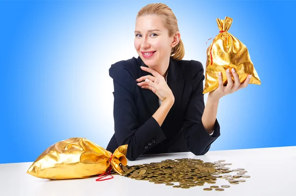 Woman with coins and golden sacks — Stock Photo, Image