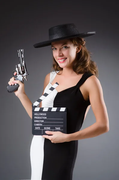 Girl with gun and clapperboard — Stock Photo, Image