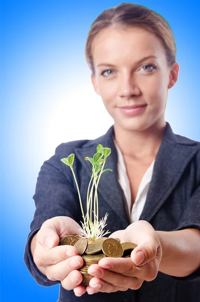 Businesswoman with seedlings and coins — Stock Photo, Image