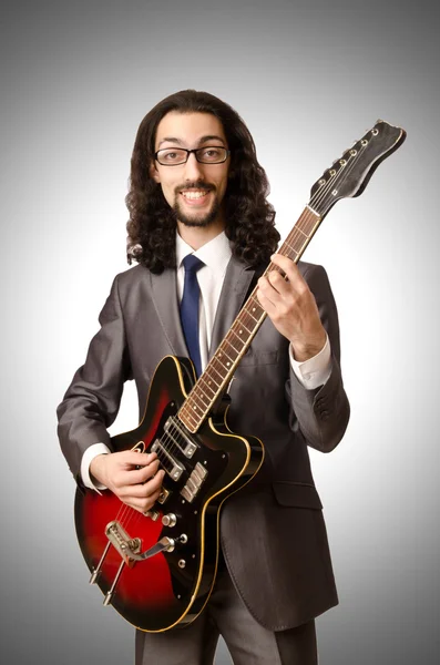 Guitar player in business suit — Stock Photo, Image