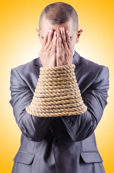 Businessman tied up with rope — Stock Photo, Image