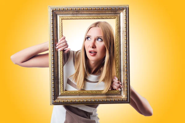 Woman with picture frame — Stock Photo, Image