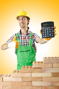 Builder and bricks against the gradient clipart