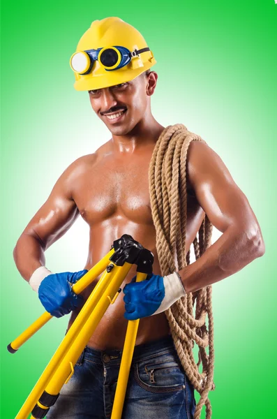 Muscular builder with tools — Stock Photo, Image