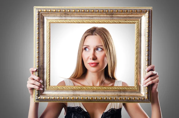 Woman with picture frames — Stock Photo, Image