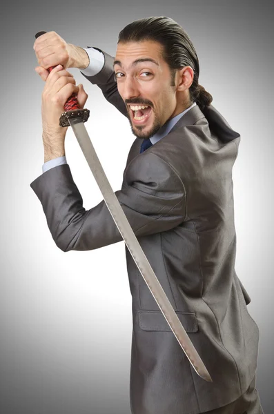 Businessman with sword against the gradient — Stock Photo, Image