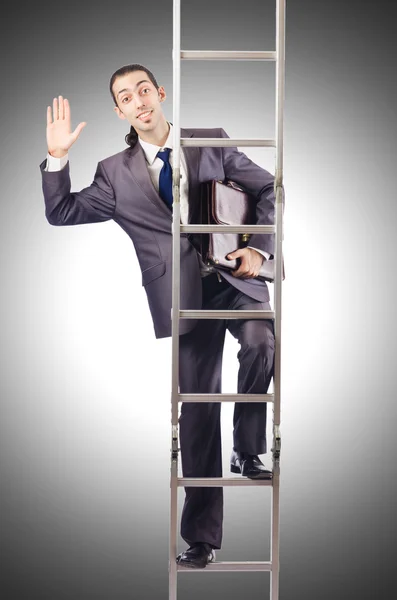 Businessman climbing the ladder against the gradient — Stock Photo, Image