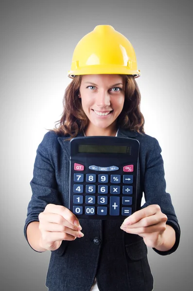 Female builder with calculator against the gradient — Stock Photo, Image