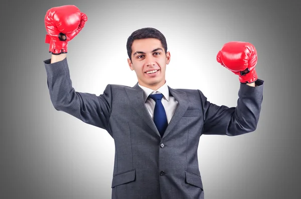 Young businessman with boxing gloves — Stock Photo, Image