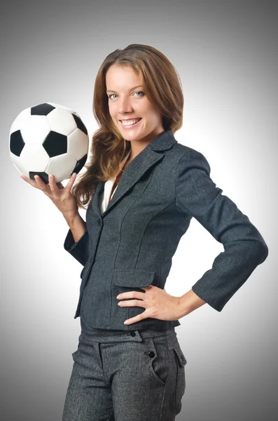 Businesswoman with football on gray — Stock Photo, Image