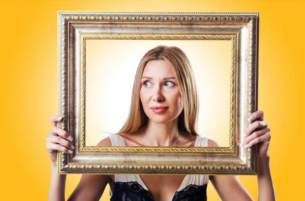 Woman with picture frame — Stock Photo, Image