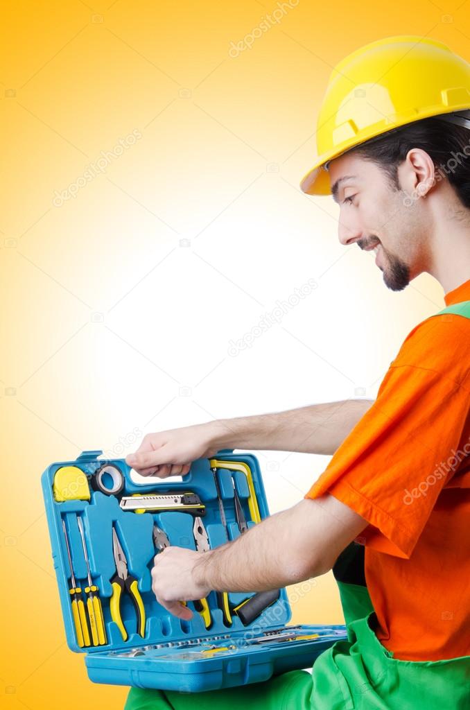 Repairman in coveralls in industrial concept