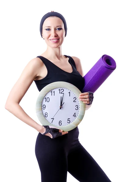 Feminino desportista segurando tapete e relógio isolado no branco — Fotografia de Stock