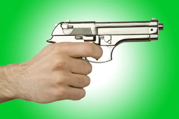 Gun in the hand against the gradient — Stock Photo, Image