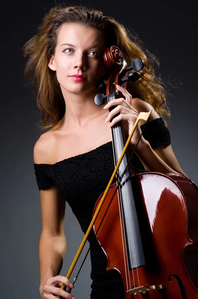 Female musical player against dark background — Stock Photo, Image
