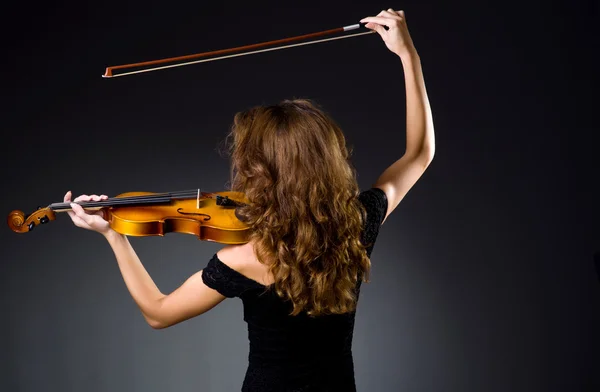 Female musical player against dark background — Stock Photo, Image
